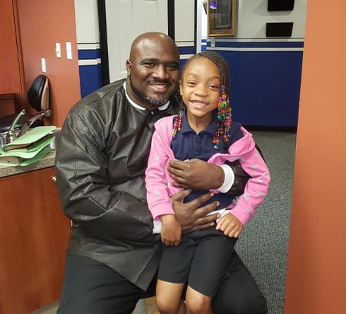 Dentist and child smiling in dental office