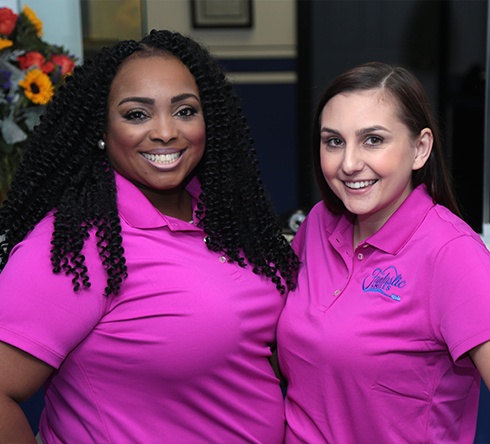 Two dental team members smiling together