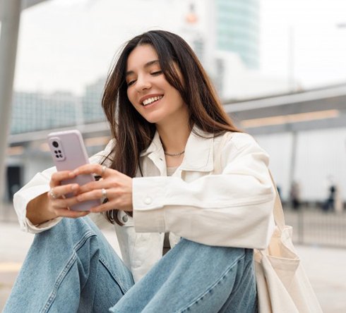 Smiling lady reads something on phone