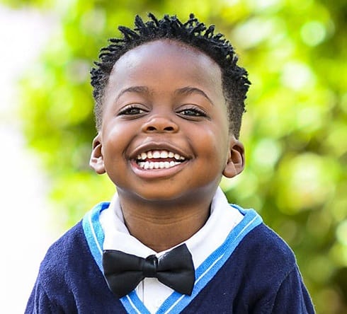 Laughing young boy with healthy smile after dental sealants