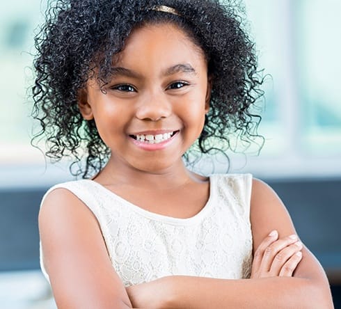 Little girl smiling after tooth colored filling treatment