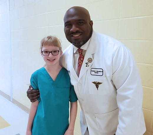 Doctor Marable and student in scrubs