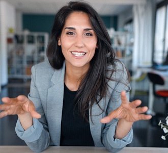 Businesswoman smiling after paying for cosmetic dentistry in Fort Valley