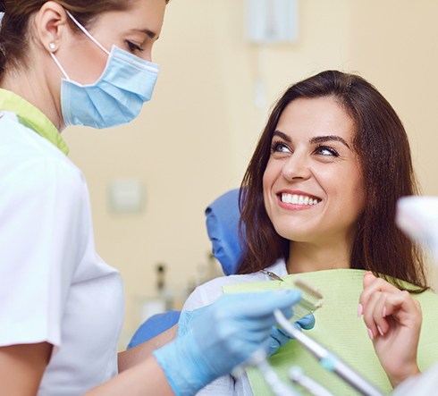 A young woman happy with the results of her dental crown