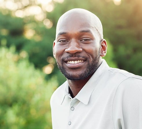 Man smiling after fixed denture  placement