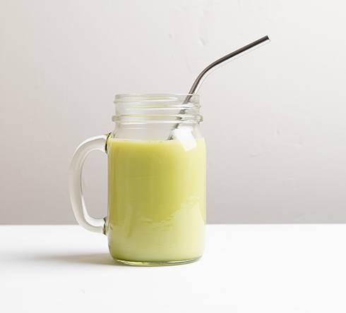 Mug of smoothie with straw