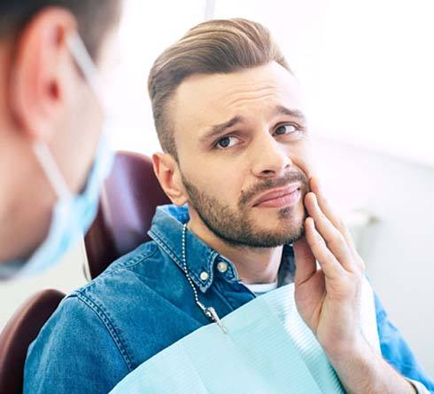 Man learning about the cost of dental emergencies in Fort Valley