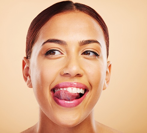 Patient in Fort Valley smiling and licking treated tooth