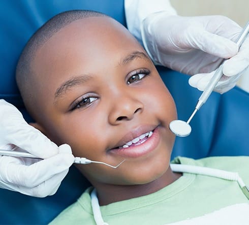 Child receiving dental treatment