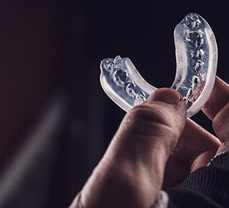 closeup of person holding mouthguard