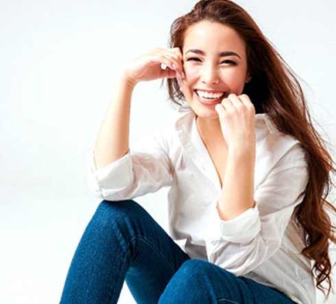 Woman in white shirt smiling with veneers in Fort Valley, GA