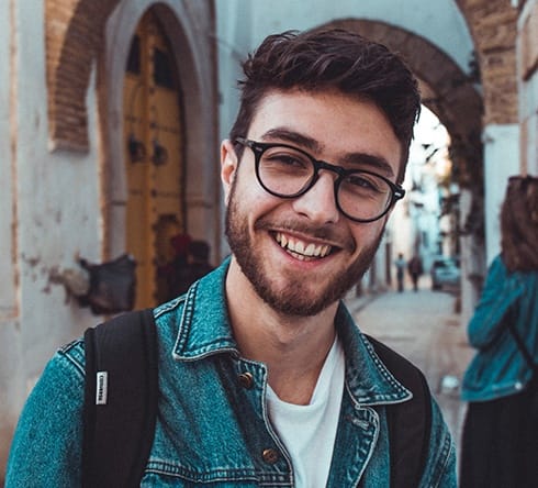 Young man with healthy smile after wisdom tooth extraction