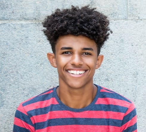 Teen boy smiling after wisdom tooth extraction