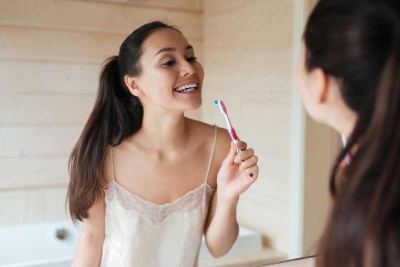 Woman brushing her veneers