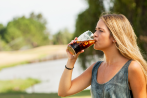 a person drinking a soda